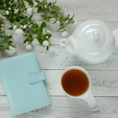 Jasmine tea. Organic  tea with jasmine extract.White teapot, jasmine tea cup and blooming jasmine...