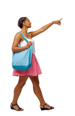 Side view of pointing African-American with a beach bag that goes to the side.