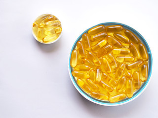 Top view of fish oil in white bowl on white table. Fish oil vitamin brain