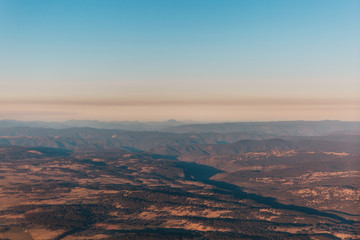 sunset in the mountains, the view from airplane