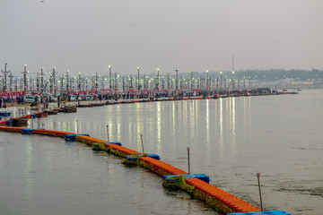 Kumbha Mela, Allahabad, Uttar Pradesh, India; 17-Feb-2019; lights on the river banks, sunset at Sangam, river Ganges