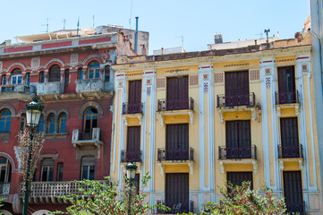Naklejka premium Greece street, facades, bright juicy colors. Red, yellow.