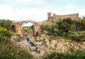 Vulci (Italy) - The medieval castle of Vulci, now museum, with Devil's bridge. Vulci is an etruscan ruins city in Lazio region, on the Fiora river between Montalto di Castro and Canino.