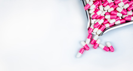 Fototapeta na wymiar Top view of pink-white capsule pills on drug tray. Antipsychotic drug. Capsule medicine for treatment depression. Anti-anxiety drug. Global healthcare. Pharmacy background. Pharmaceutical industry.