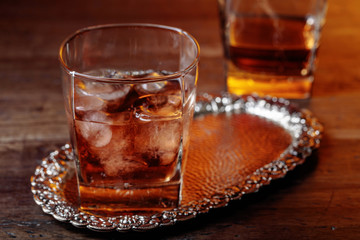 Glass of scotch whiskey and natural ice .