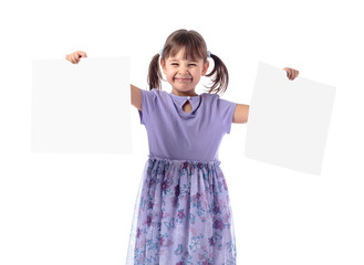 Happy girl in a purple dress shows her drawings.