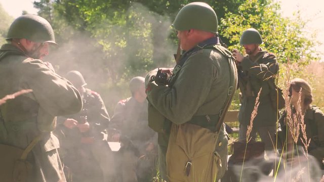 Soldiers in camp, smoke in front
