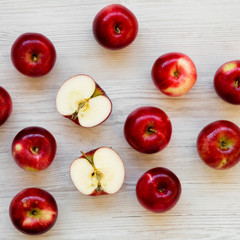 Raw red apples on white wooden surface, overhead view. Flat lay, from above, top view. Closeup.