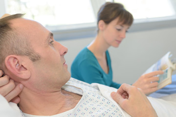 reading a story to the patient