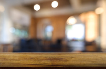Empty wooden table in front of abstract blurred background of restaurant, cafe and coffee shop interior. can be used for display or montage your products - Image.