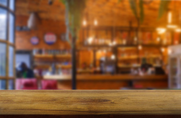 Empty wooden table in front of abstract blurred background of restaurant, cafe and coffee shop interior. can be used for display or montage your products - Image.