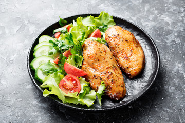 Grilled chicken breast. Fried chicken fillet and fresh vegetable salad .