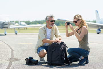 reporters checking the capture pictures on the tarmac