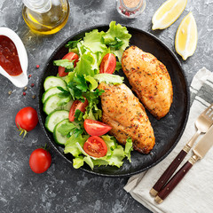 Grilled chicken breast. Fried chicken fillet and fresh vegetable salad .