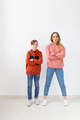 Mothers day, children and family concept - teen boy and his mom posing on white background