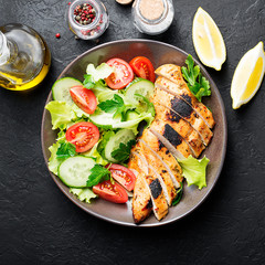 Grilled chicken breast. Fried chicken fillet and fresh vegetable salad .