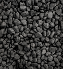 black stone background, many dark pebble stones -