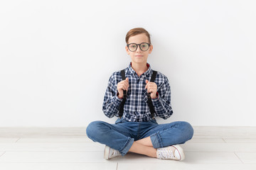 teenager, children and fashion concept - Portrait of kid dressed in plaid shirt posing over white background