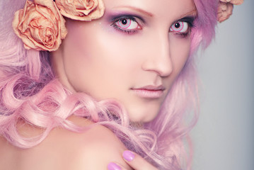 Beautiful and young girl with pink hair in coloured crazy contact lenses