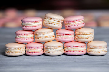 Macaron cookies in white bowl Sweet and colorful french macaroons Close up colorful macarons dessert with vintage pastel tones