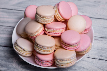 French colorful macarons background, close up macaron or macaroons cookie, tasty dessert. food background Plate of fresh colorful macarons