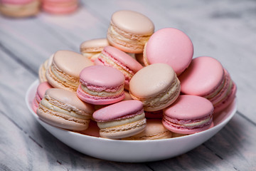 Fototapeta na wymiar Close up colorful macarons dessert with vintage pastel tones French colorful macarons background, close up macaron or macaroons cookie, tasty dessert. food background