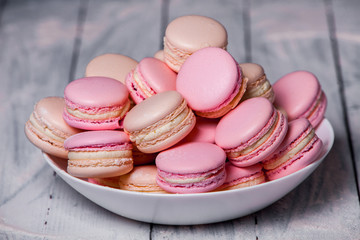 Close up colorful macarons dessert with vintage pastel tones French colorful macarons background, close up macaron or macaroons cookie, tasty dessert. food background