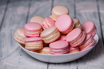 French colorful macarons background, close up macaron or macaroons cookie, tasty dessert. food background Plate of fresh colorful macarons