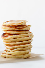  Stack of plain pancakes оn white background with free space for design and text