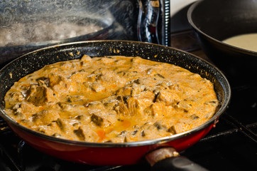 cooking meat in frying pan