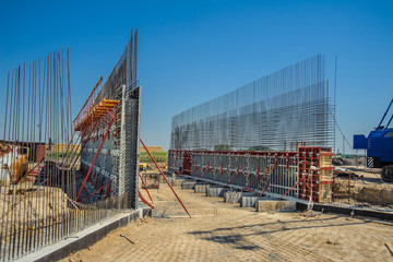 Forming the walls of the tunnel with metal panels formwork against the sky.