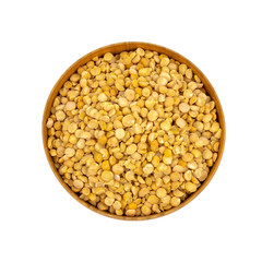 Raw yellow split peas in a wooden plate (bowl) isolated on white background, top down view