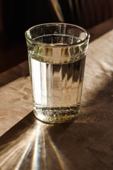 a glass of water with sunshine and sun rays