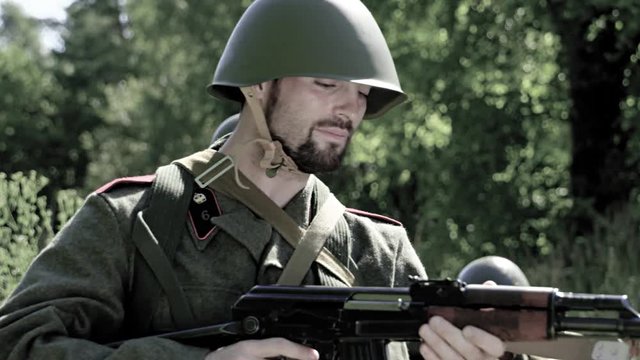 A soldier tries to reload his rifle