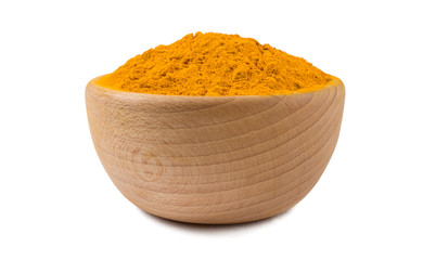 turmeric powder in wooden bowl isolated on white background. Spices and food ingredients.