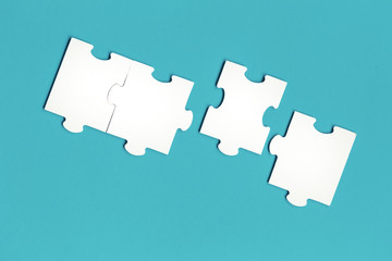 Jigsaw puzzle matching pieces. Teamwork and solution or idea concept with copy space on trendy blue background