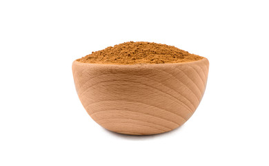 ground or milled cinnamon in wooden bowl isolated on white background. Spices and food ingredients.