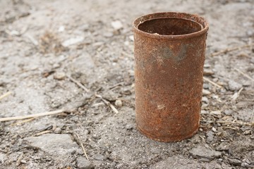close up old rusty can on the ground