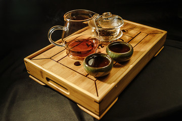 Tea ceremony on the river bank. process of brewing tea in nature using a glass teapot
