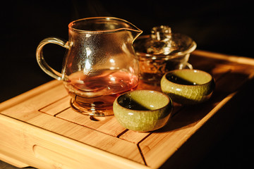 Tea ceremony on the river bank. process of brewing tea in nature using a glass teapot