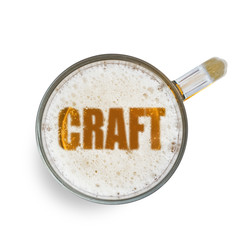 Inscription craft on the beer foam in glass isolated on white background. Top view