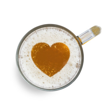 Sign heart on the beer foam in glass isolated on white background. Top view