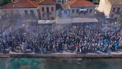 Aerial drone bird's eye view photo of people participating in traditional colourful flour war or...