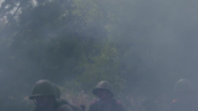 Soldiers moving a anti tank gun forward on a battlefield