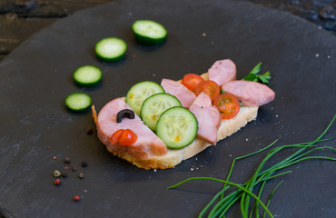 Children's ham sandwich made in the form of fish. Option of children's serving