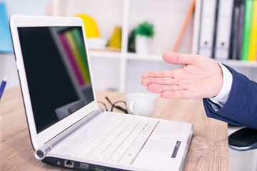 successful businessman working on laptop with financial data at the workplace in a modern office