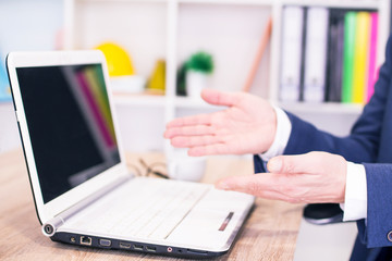 Fototapeta premium successful businessman working on laptop with financial data at the workplace in a modern office