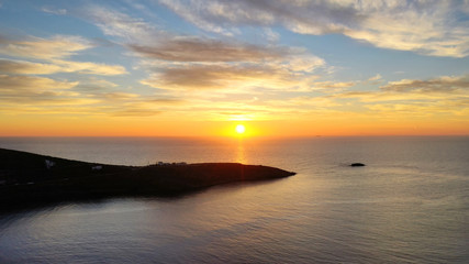 Fototapeta na wymiar Aerial drone panoramic photo of beautiful sunset over the Aegean sea with golden colours, Greece