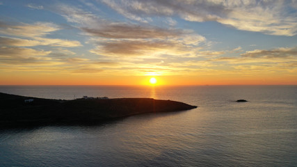 Aerial drone panoramic photo of beautiful sunset over the Aegean sea with golden colours, Greece