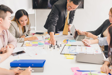 A group of Asian businessmen are discussing their work.All people share brainstorm ideas at work.